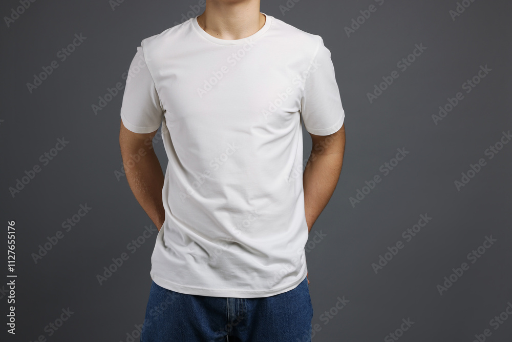Man in stylish t-shirt on grey background, closeup. Mockup for design