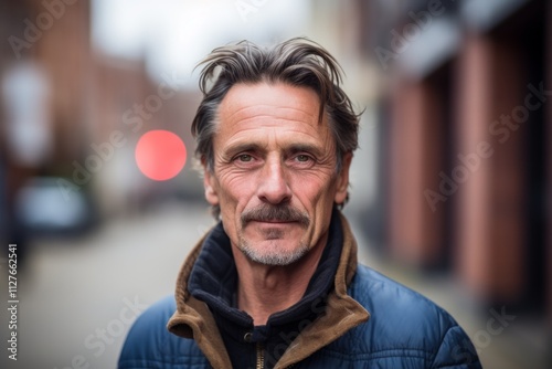 Portrait of a senior man looking at the camera in the city