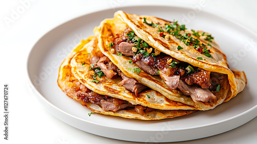 Delicious Chinese Peking duck pancakes filled with tender meat and herbs