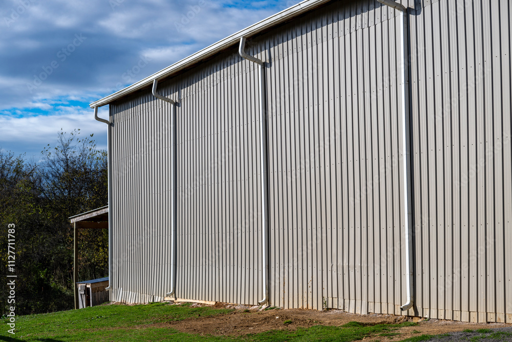 Fototapeta premium A modern big warehouse metal wall with gutters