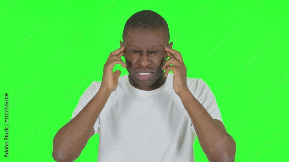 Portrait of African Man with Migraine on Green Background Portrait of African Man with Migraine on Green Background
