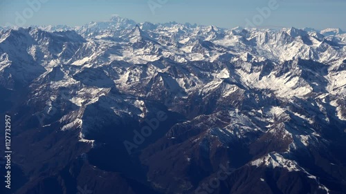 Top bird eye View from passenger porthole of beautiful landscape Flying airplane engine wing of plane fly on sunny cloudy day in winter. Transport, tourism, travel, flight, holidays vacation concept.