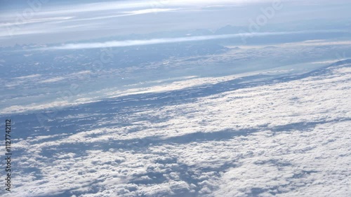 Top bird eye View from passenger porthole of beautiful landscape Flying airplane engine wing of plane fly on sunny cloudy day in winter. Transport, tourism, travel, flight, holidays vacation concept.