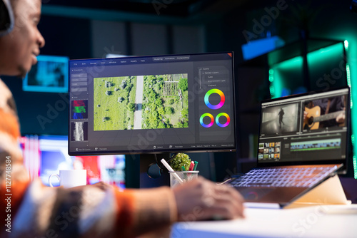 Videography specialist editing new movie clip for video montage, working on freelance contract for post production agency. Creative designer adjusting contrast and exposure using toolbar panels. photo