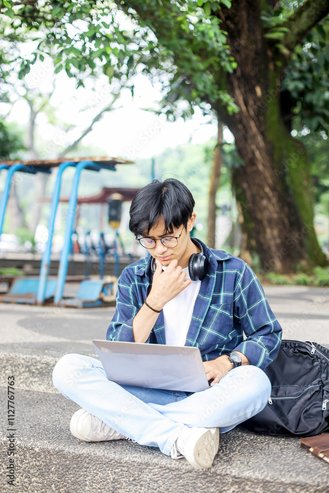 Asian Student Boy Using Laptop in Park Asian Student Boy Using Laptop in Park