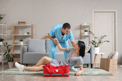 Male doctor helping woman w...