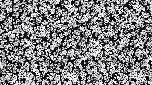 A dense pattern of small white flowers on a black background, suitable for textiles or wallpapers.