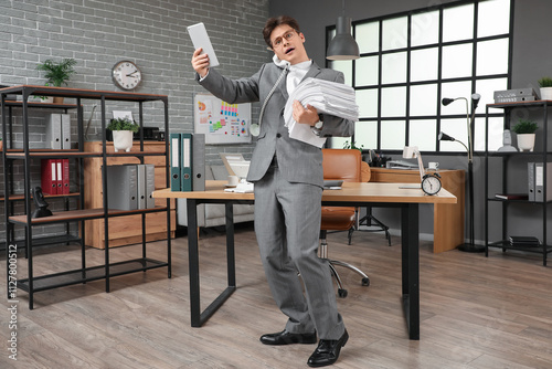 Wallpaper Mural Stressed businessman with tablet computer and papers trying to meet deadline in office Torontodigital.ca