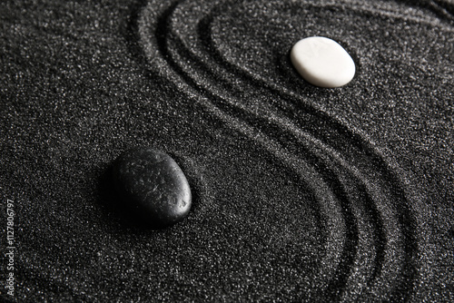 Canvas Print Stones on black sand with pattern in Japanese rock garden