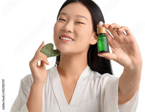 Young Asian woman with gua sha and oil on white background, closeup photo