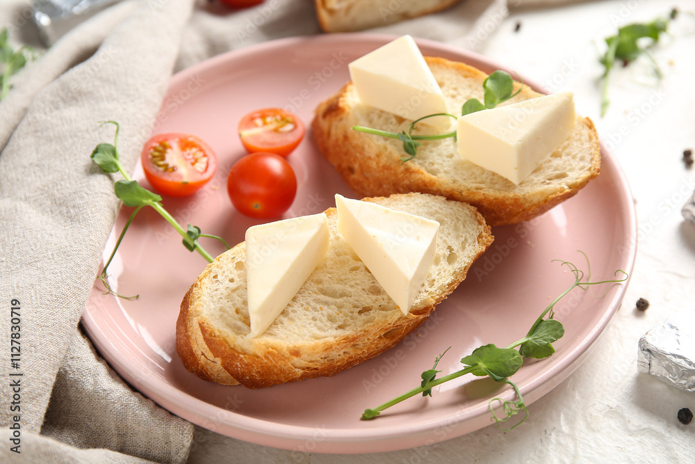 Plate with bread, triangles of tasty processed cheese, tomatoes and micro green on light table, closeup Plate with bread, triangles of tasty processed cheese, tomatoes and micro green on light table, closeup