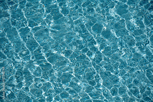 Water texture. View of swimming pool surface. Blue water background. Blue water texture background. Surface of pool water.
