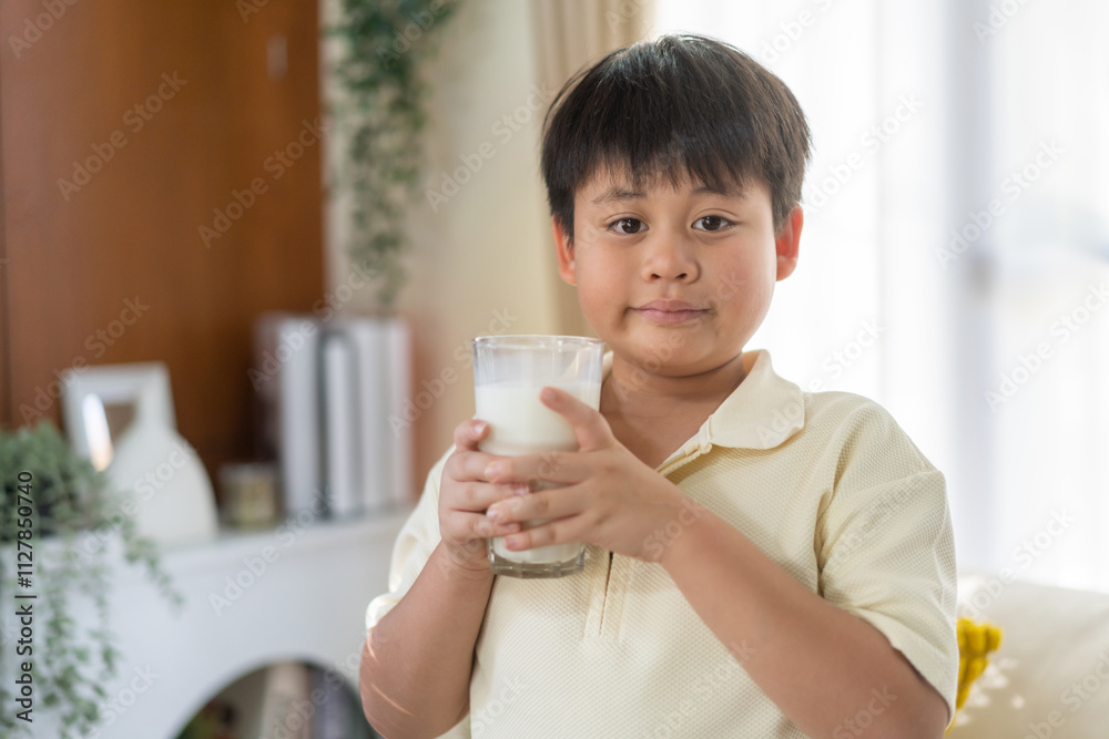 Asian boy drinking milk for healthy growth in protein and calcium, promoting strong bones natural nutrition development, wellness vitality dairy beverage, happy childhood lifestyle, family care fresh Asian boy drinking milk for healthy growth in protein and calcium, promoting strong bones natural nutrition development, wellness vitality dairy beverage, happy childhood lifestyle, family care fresh