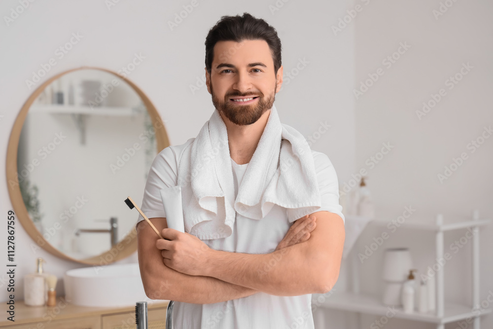 Morning of handsome man with tooth brush and paste in bathroom Morning of handsome man with tooth brush and paste in bathroom