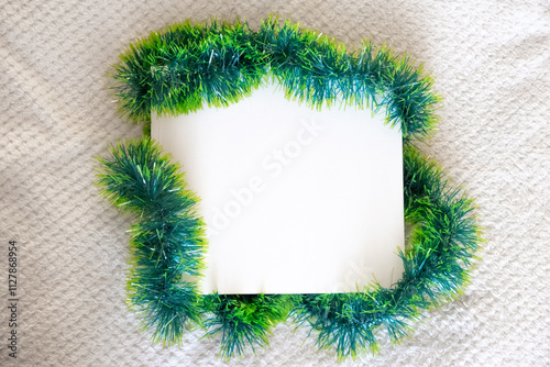 A book with a white cover in green tinsel. Mockup template.