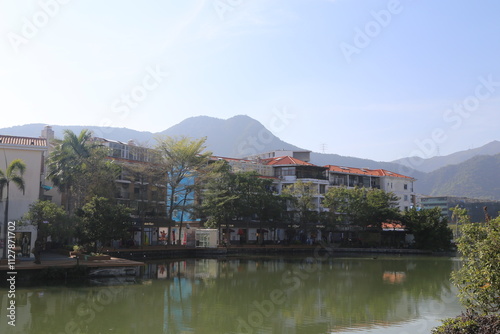 A river runs through a town with a view of mountains in the background