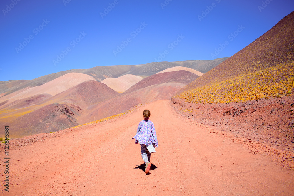 Little girl walking in colorful mountains Little girl walking in colorful mountains
