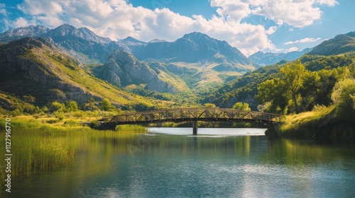 Scenic mountain landscape with a bridge over a tranquil river.