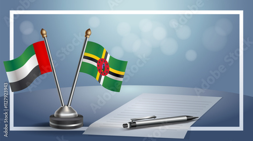 United Arab Emirate and Dominica National flags on small table with bokeh background, cooperative relationship