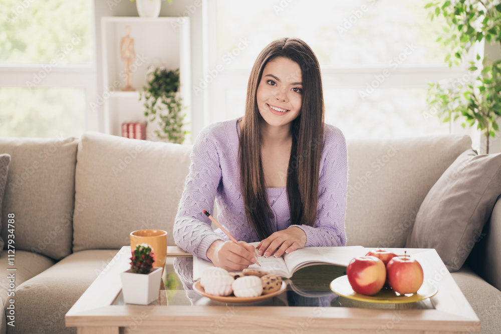 Photo of lovely young teen girl study do homework dressed violet garment spacious house bright indoors room Photo of lovely young teen girl study do homework dressed violet garment spacious house bright indoors room