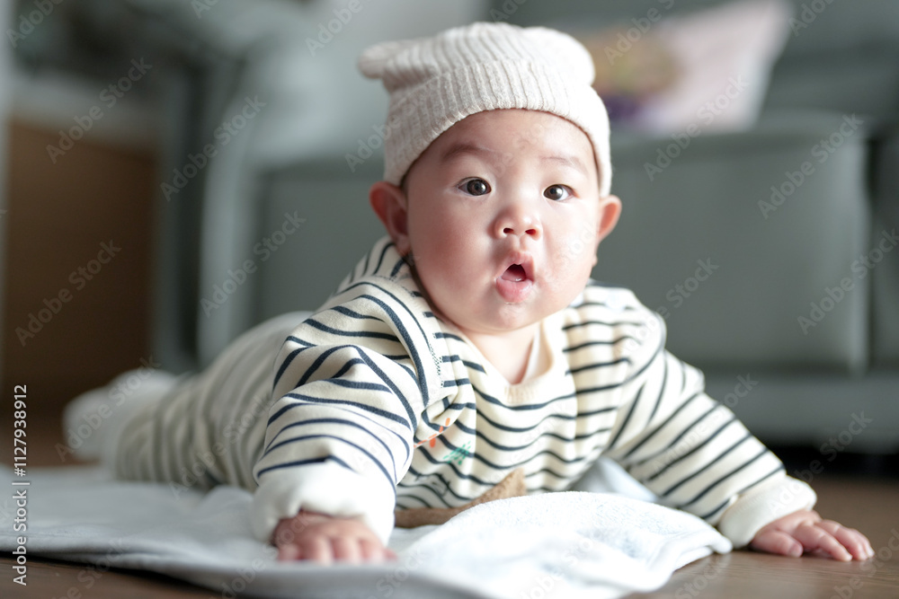 A six-month-old Chinese boy lies on the floor in an apartment building in Pudong New District, Shanghai, China on a cold winter day. A six-month-old Chinese boy lies on the floor in an apartment building in Pudong New District, Shanghai, China on a cold winter day.