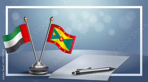 United Arab Emirate and Grenada National flags on small table with bokeh background, cooperative relationship