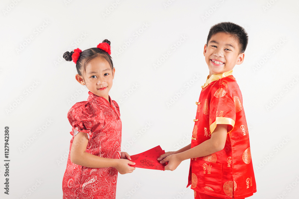 Chinese New Year. Happy Asian little kid sibling boy and girl wear red cheongsam qipao giving red hongbao envelope packet monetary gift Chinese New Year. Happy Asian little kid sibling boy and girl wear red cheongsam qipao giving red hongbao envelope packet monetary gift