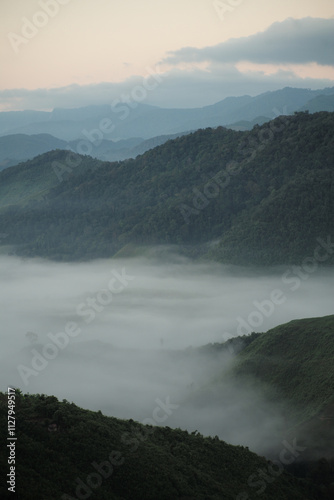 Panorama view layers of mountain with the fluffy white fog between the mountains and clear sky in background