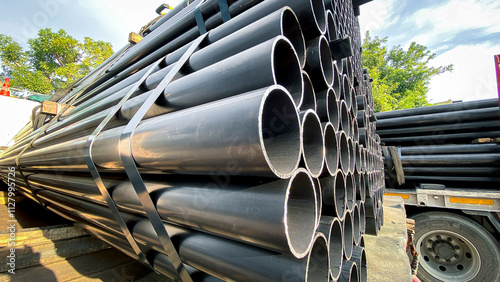 Construction products on transport vehicles Group of steel pipes for industrial materials Construction engineering products  equipment, steel pipes, metal warehouse industry, delivery to customers