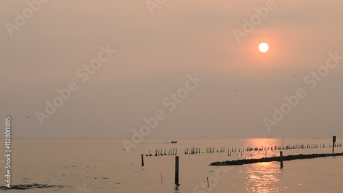 The sun is setting and the sea is golden.