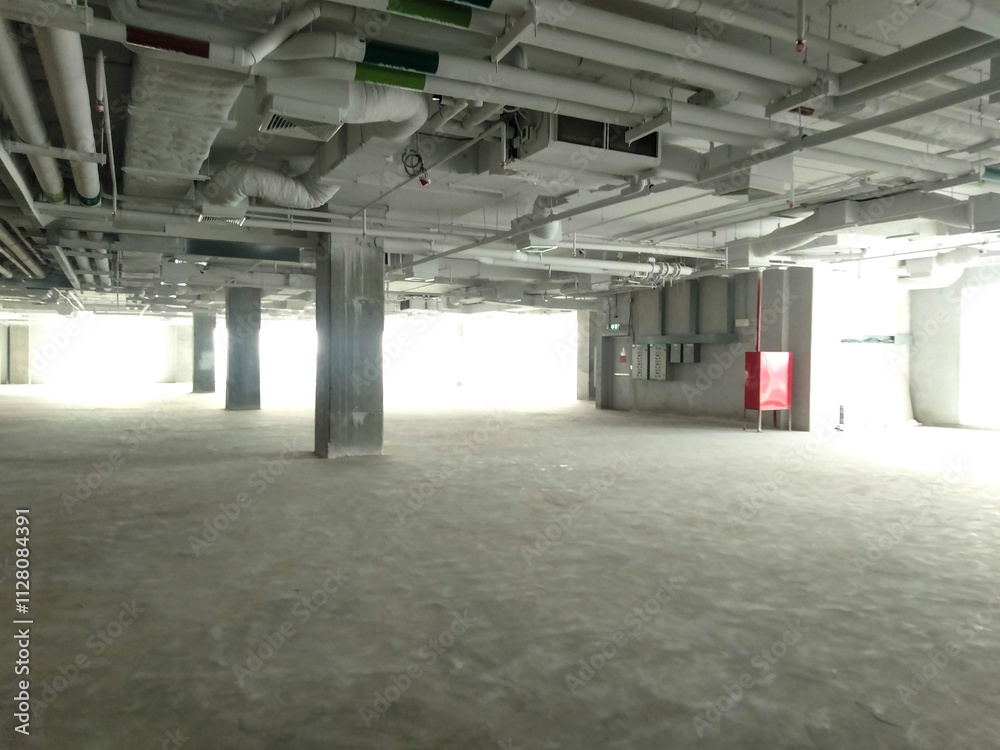 Open Industrial Space Showing Structural Elements and Organized Ceiling Facilities Open Industrial Space Showing Structural Elements and Organized Ceiling Facilities