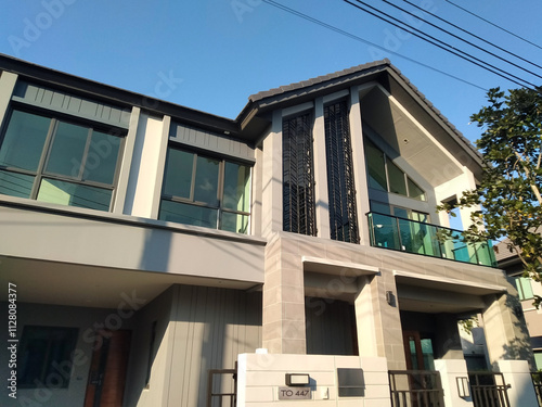 Modern Two-Story Residential House With Minimalistic Design and Large Glass Windows.