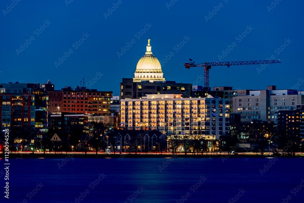 Downtown Madison, WI and the Wisconsin State Capitol Building behind Lake Monona at Twilight