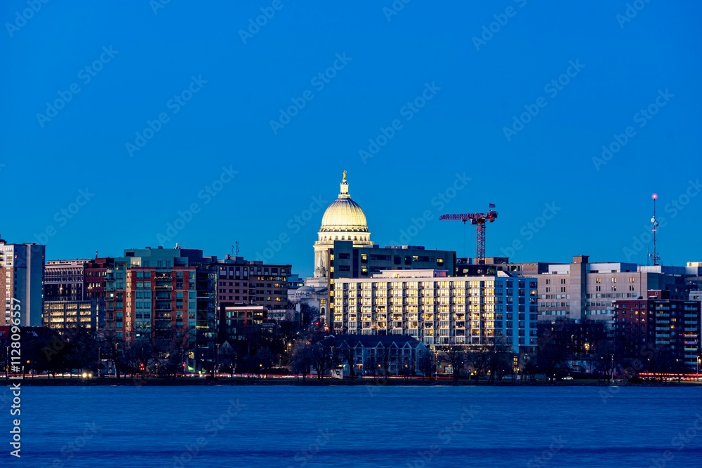 Downtown Madison, WI and the Wisconsin State Capitol Building behind Lake Monona at Twilight