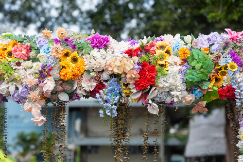 Multi-colored artificial flowers are beautifully arranged together.