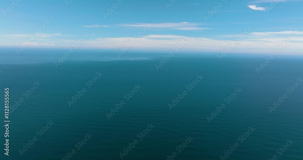 Aerial drone of open blue sea with waves against the sky and clouds. Seascape in the tropics. Borneo, Malaysia. Aerial drone of open blue sea with waves against the sky and clouds. Seascape in the tropics. Borneo, Malaysia.