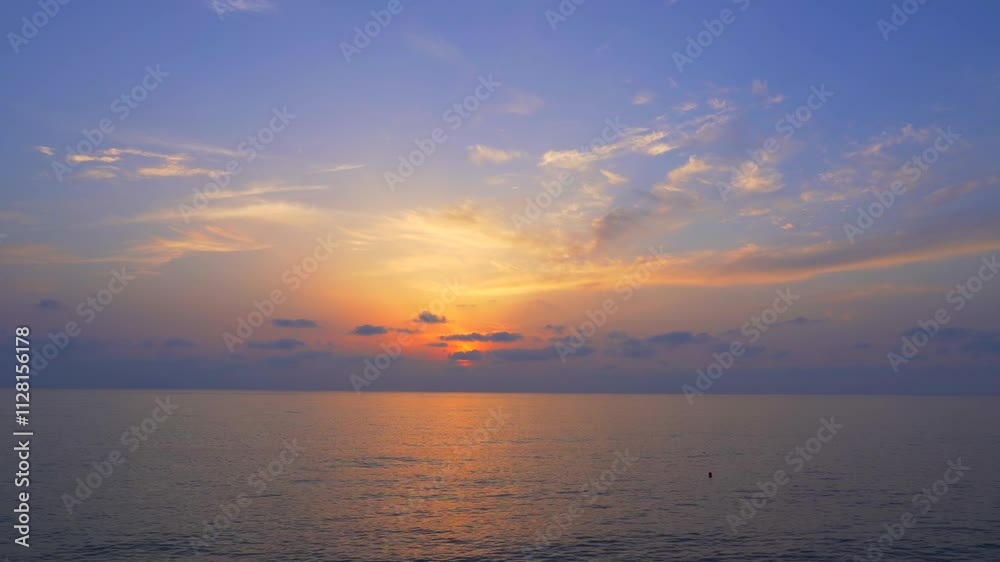 Sunset over calm ocean, featuring soft hues of orange, pink, and purple blending in sky above horizon. Sunset over calm ocean, featuring soft hues of orange, pink, and purple blending in sky above horizon.