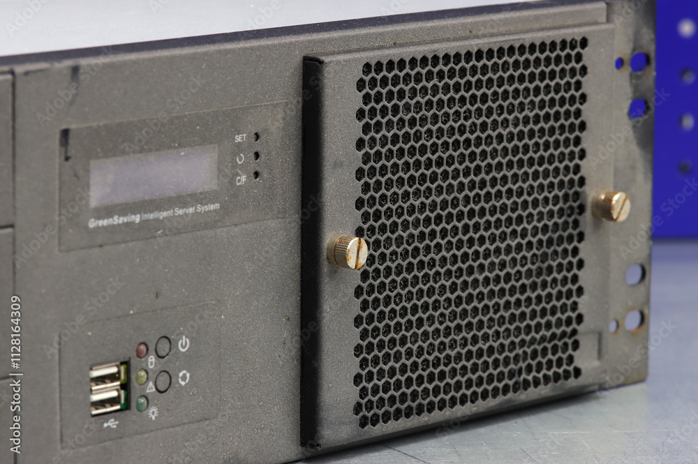 Obraz premium A rusty metal screw securing the computer server panel. Close-up. Soft focus.