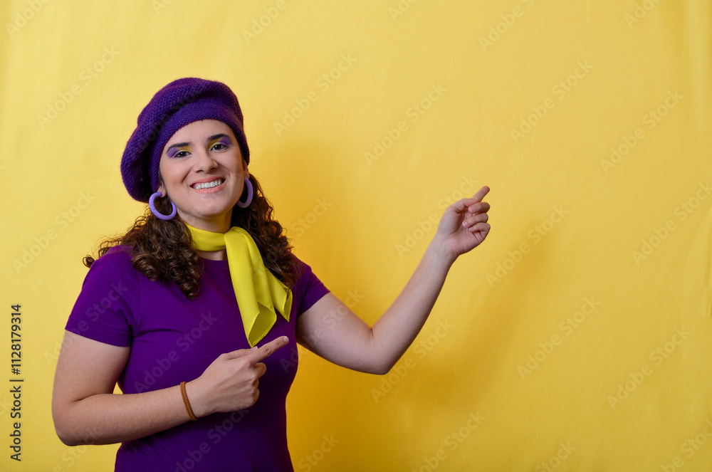 Smiling woman pointing aside and down on yellow background Smiling woman pointing aside and down on yellow background