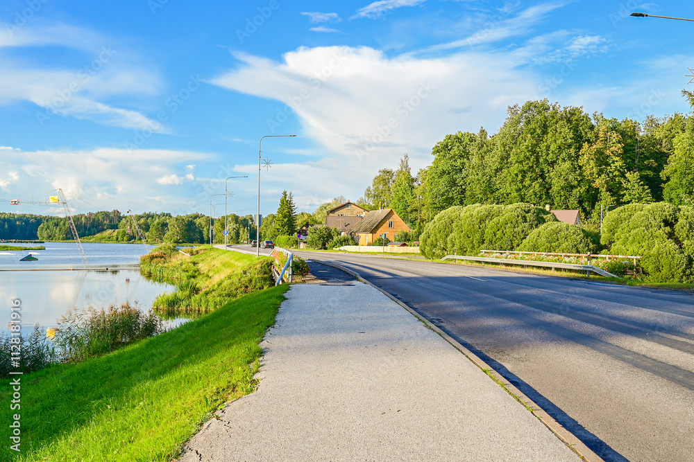 Fototapeta premium Straße am See bei Beautifully located wake park or water ski park on the lake near Põlva, Polwa with water and green trees in summer, in southern Estonia 