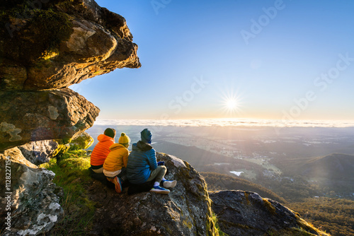 Mother with kids enjoying the sunrise view from Boroka Lookout cliff at Grampians Mountains, Victoria, Australia
