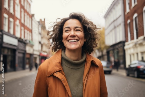 Portrait of a smiling young woman walking on a street in London