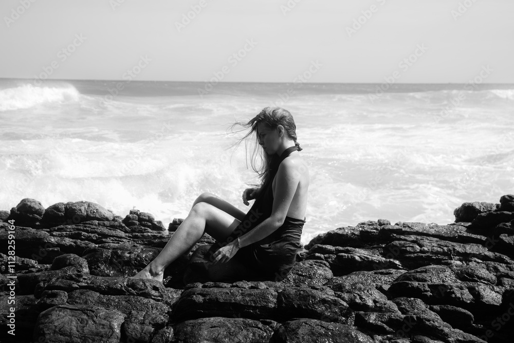 Woman on the rocks of a beach Woman on the rocks of a beach