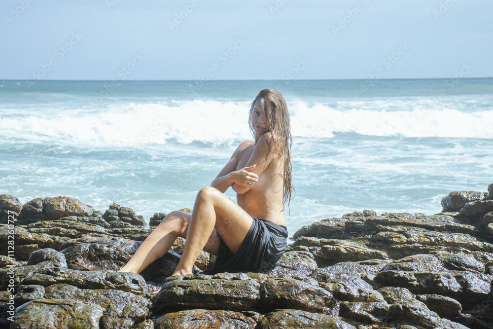 Woman on the rocks of a beach Woman on the rocks of a beach