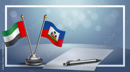 United Arab Emirate and Haiti National flags on small table with bokeh background, cooperative relationship