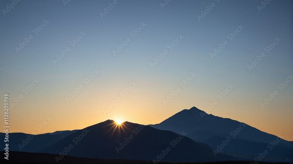 the sun is setting behind the mountains