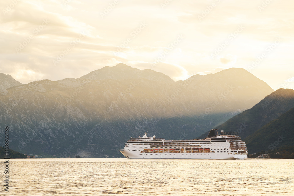 Large white cruise ship sailing on tranquil waters, bathed in the golden light of sunset, against a backdrop of majestic mountains Large white cruise ship sailing on tranquil waters, bathed in the golden light of sunset, against a backdrop of majestic mountains