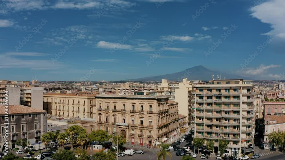 Drone shot of residential buildings in Catania with volcano Etna in the background. Urban area. Streets with cars. Drone shot of residential buildings in Catania with volcano Etna in the background. Urban area. Streets with cars.