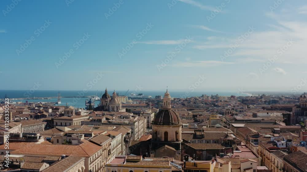 Flying towards cathedral tower in the historic city of Catania. UNESCO World heritage site. Aerial old town view with sea port in the background. Flying towards cathedral tower in the historic city of Catania. UNESCO World heritage site. Aerial old town view with sea port in the background.