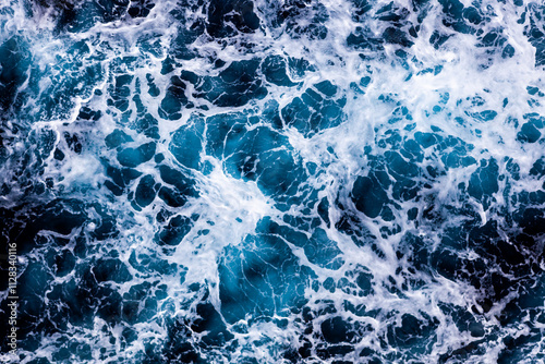 Ocean water background. Top view of vibrant foamy water. Can be used in covers, packaging, posters, textures, brochures, art and design projects. Captivating nature background image.